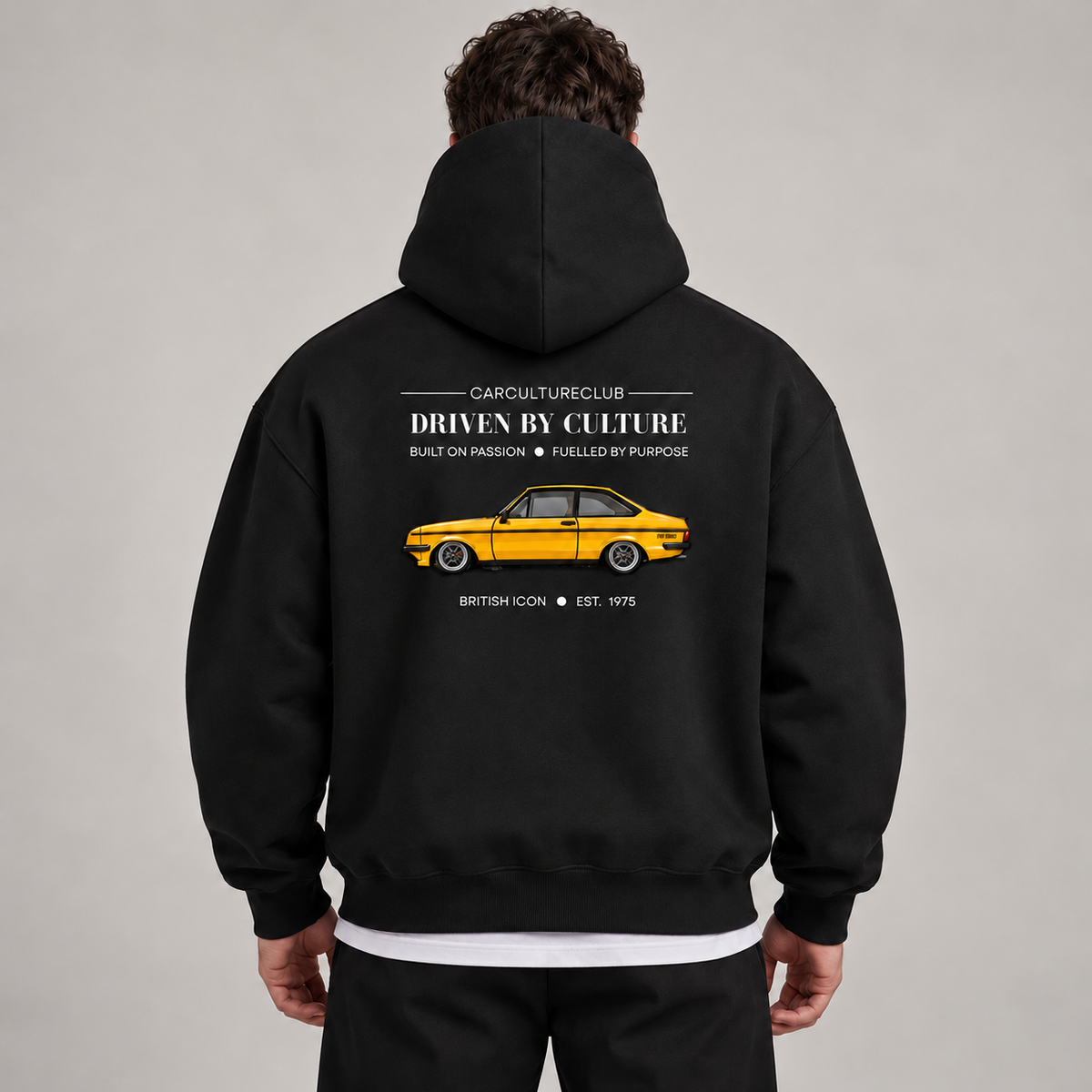 British Icon black hoodie styled over a white T-shirt in the studio