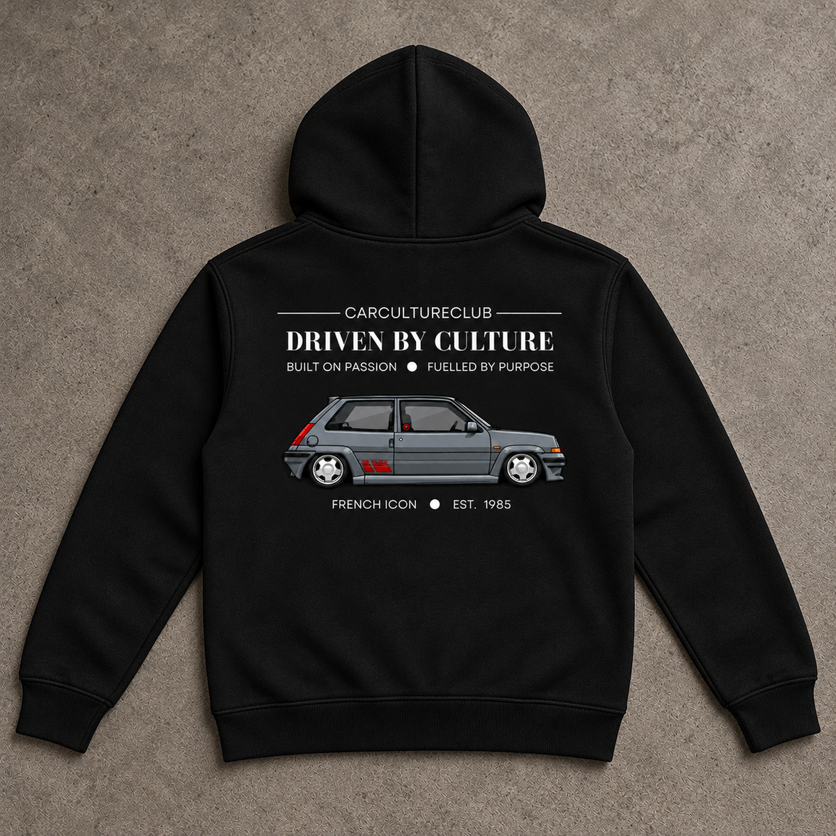 French Icon Hoodie — Black, full back flat lay on stone