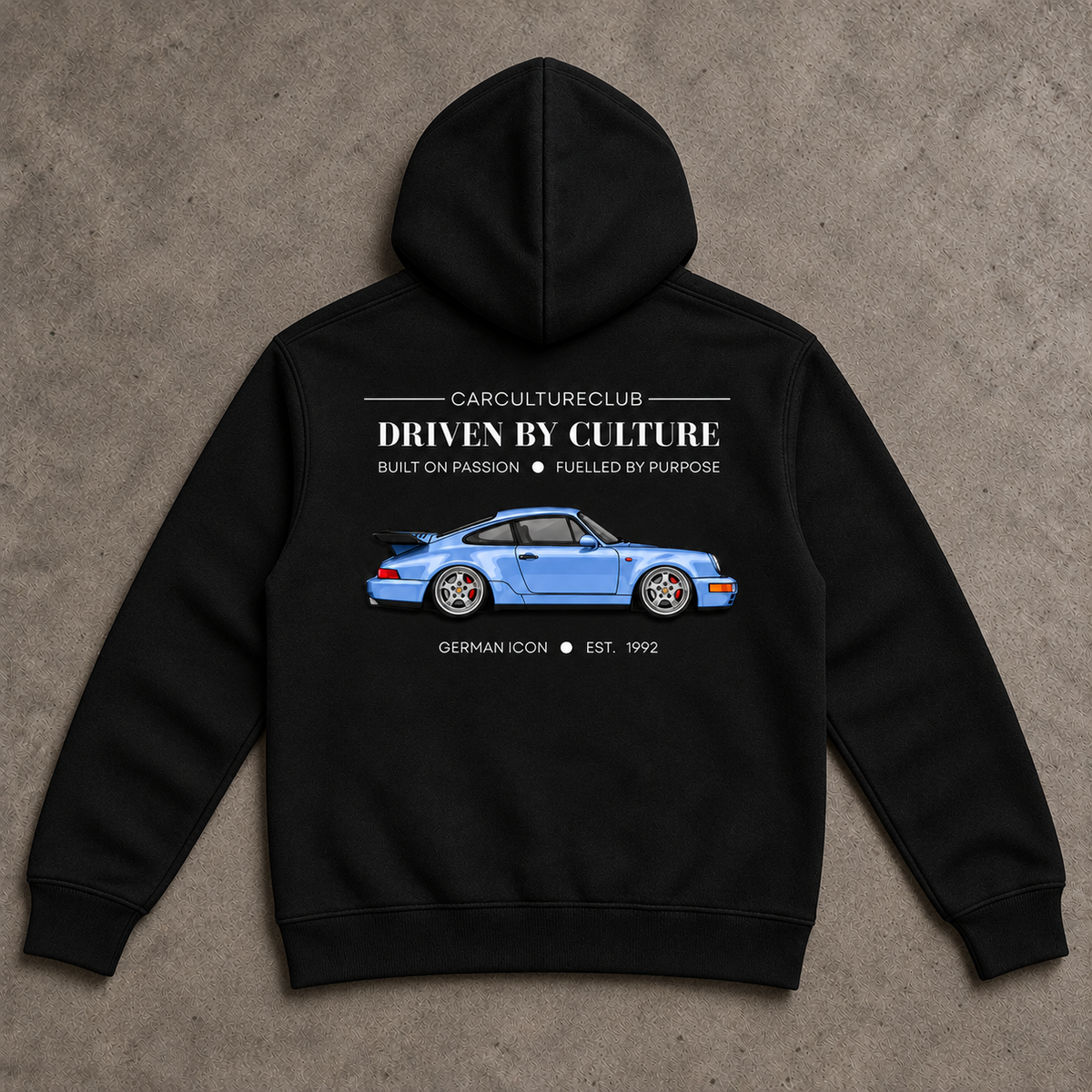 German Icon Hoodie — Black, full back flat lay on stone