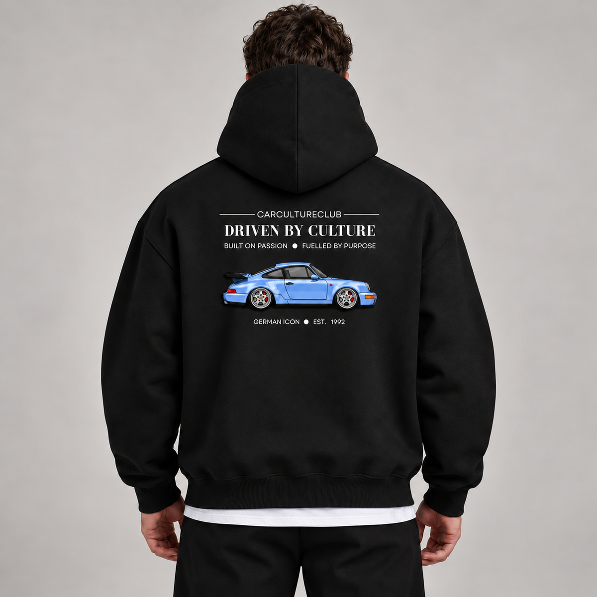 German Icon Hoodie — Black, studio view with white T-shirt layer